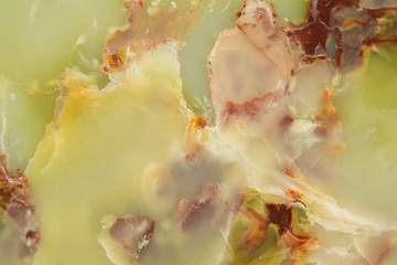 Wall Mural - Lightened slices marble onyx. Horizontal image. Warm green colors. Beautiful close up background