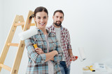 Fototapeta  - Happy couple painting their new home