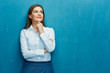 © Yuriy Shevtsov - Smiling young business woman portrait on blue wall background.