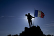 Soldier on top of the mountain with the French flag