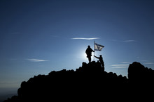 Two Soldiers Raise The Israeli Flag On Top Of The Mountain