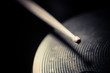 Close up shot of a drumstick hitting a cymbal.