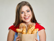 © Yuriy Shevtsov - Smiling woman holding bag with bread.