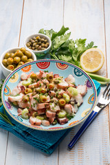 Canvas Print - octopus salad with capers celery and green olives and lettuce