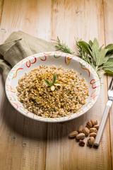 Canvas Print - barley risotto with herbs and pistachio nuts