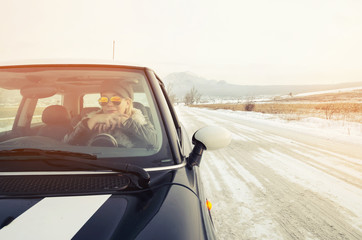 Hipster woman sitting in a small car