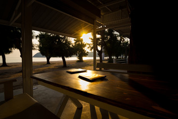 dining table and food menu book with golden light on sunset at s