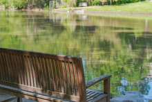 Peaceful Spot To Sit And Relax.  Park Bench With Lake. 