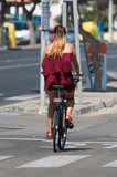 Fototapeta Miasto - Woman riding on bicycle around the city.