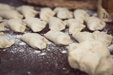 Homemade Dumplings prepared on the wooden brown table by traditional way