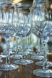 © Evgenii Starkov - Clean glasses on a table prepared by the bartender for champagne and wine.