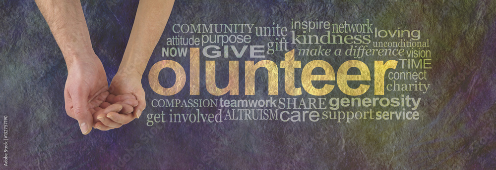 We can volunteer together - male hand cupped by a female hand making the V of VOLUNTEER surrounded by a word cloud on a rustic dark colored stone effect background - obrazy, fototapety, plakaty 
