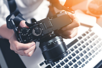 Photographer Workstation. Modern Digital DSLR Camera, Laptop and accessory.