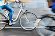 bicycle riders in city traffic in motion blur