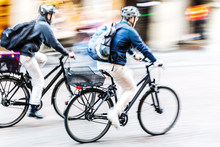 Bicycle Riders In City Traffic In Motion Blur