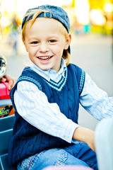 Wall Mural - Portrait of happy childhood. Stylish little boy in blue hat, swe