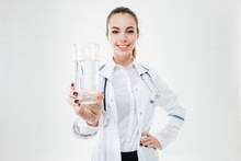 Happy Woman Doctor Standing And Giving Young Glass Of Water