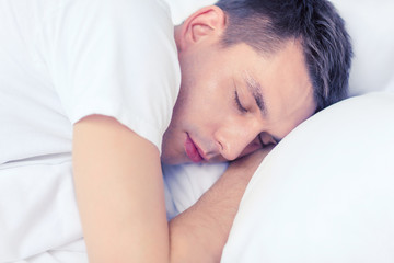 Wall Mural - handsome man sleeping in bed