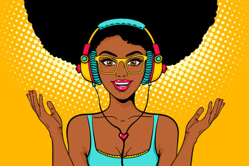 young sexy african american black woman with open smile in headphones listening to the music and spr