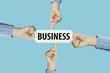 © Thermchai - Many hands fingers pointing with index fingers to BUSINESS text
