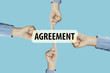 © Thermchai - Many hands fingers pointing with index fingers to AGREEMENT text