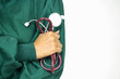 © NaruFoto - Doctor holding stethoscope, wearing a green uniform on white background