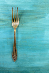 Wall Mural - Vintage fork on vibrant turquoise with copyspace