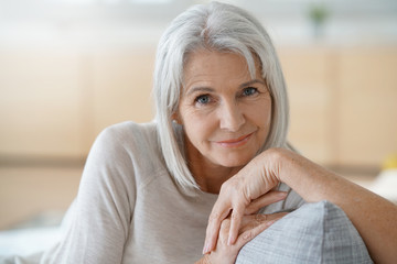 Wall Mural - Portrait of senior woman relaxing in sofa