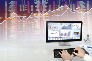 Fototapete - Man analyzing financial data and charts on computer 