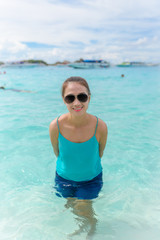 Woman standing in the turquoise water