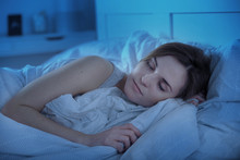 Girl Peacefully Sleeping In Bed At Night