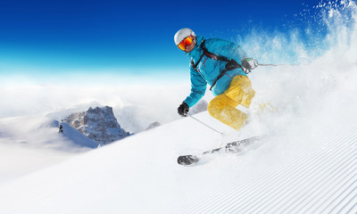 Skier on piste running downhill