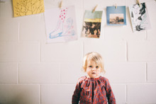 Portrait Of Young Girl, Pictures Hanging On Wall Behind Her