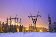 power transmission line poles in the winter evening