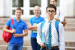 © Africa Studio - Student with classmates outside the school