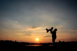 © songphon - Family concept, Silhouette of father throwing son into the sky.