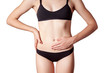 © khosrork - Closeup view of a young woman with stomach pain or digestion or period cycle . isolated on white background.
