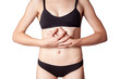 © khosrork - Closeup view of a young woman with stomach pain or digestion or period cycle . isolated on white background.