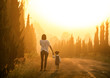 © DN6 - Mother and child holding hands at sunset with copy space, view f