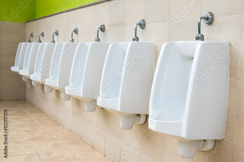 Fotografía row of outdoor urinals men public toilet,Closeup white urinals i