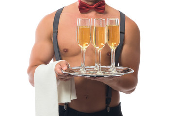 Glasses of champagne on a tray on the background of male breast