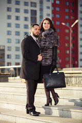 Happy young fashion couple walking on city street