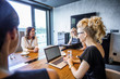 © Lumi Images - Businesswomen discussing while sitting in meeting
