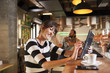 © Lumi Images - Woman in coffee shop using digital tablet
