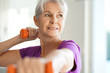 © goodluz - Portrait of senior woman lifting dumbbells