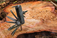 Multifunction Knife Stuck On The Tree Stump. 