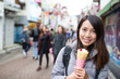 © leungchopan - Young Woman enjoy her crape cake at street