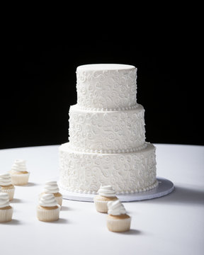 three tiered wedding cake with black background