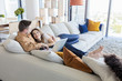 © Lumi Images - Couple relaxing in modern apartment