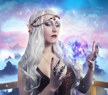 Elf Girl Photo. Beautiful Elf Girl Holding A Magic Ball On Fantasy Background Photo.